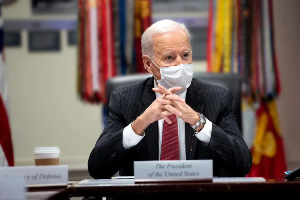 An image of President Joe Biden at a meeting in the White House while wearing a mask in February 2021.